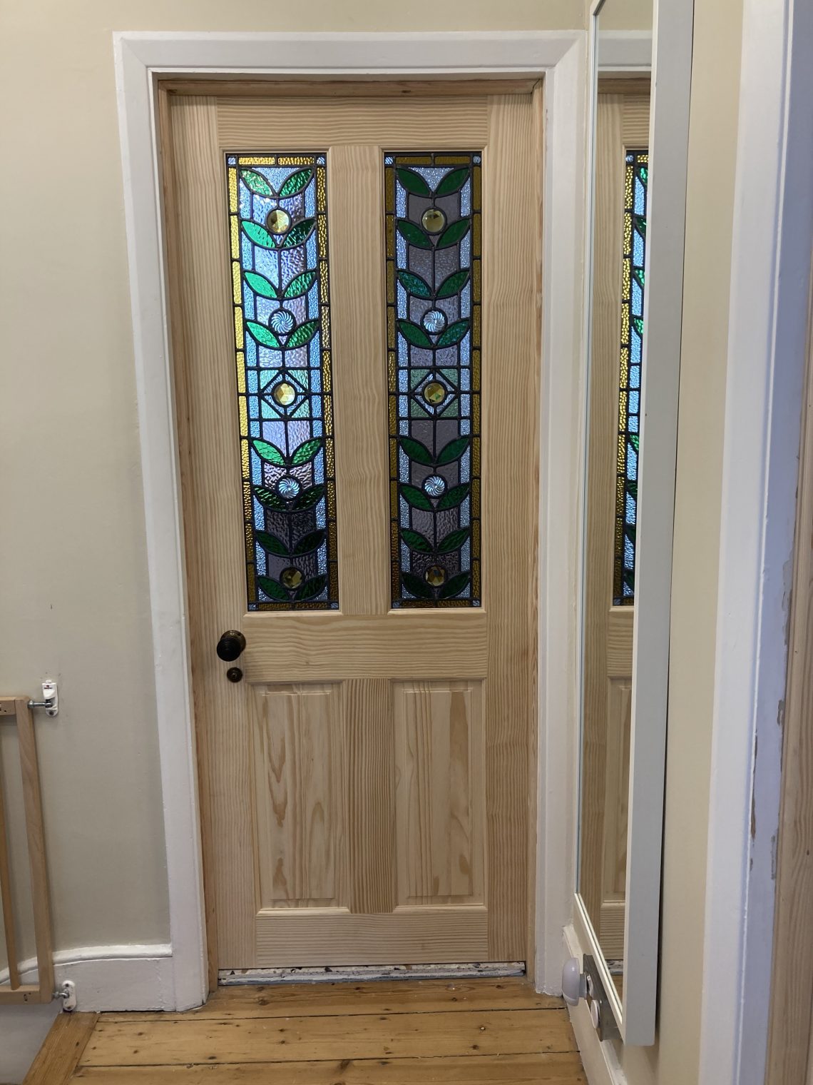 After a great deal of finessing this new pine door from trade was fitted, with its new handles and latches.  The glass was added after hanging by a glazier.